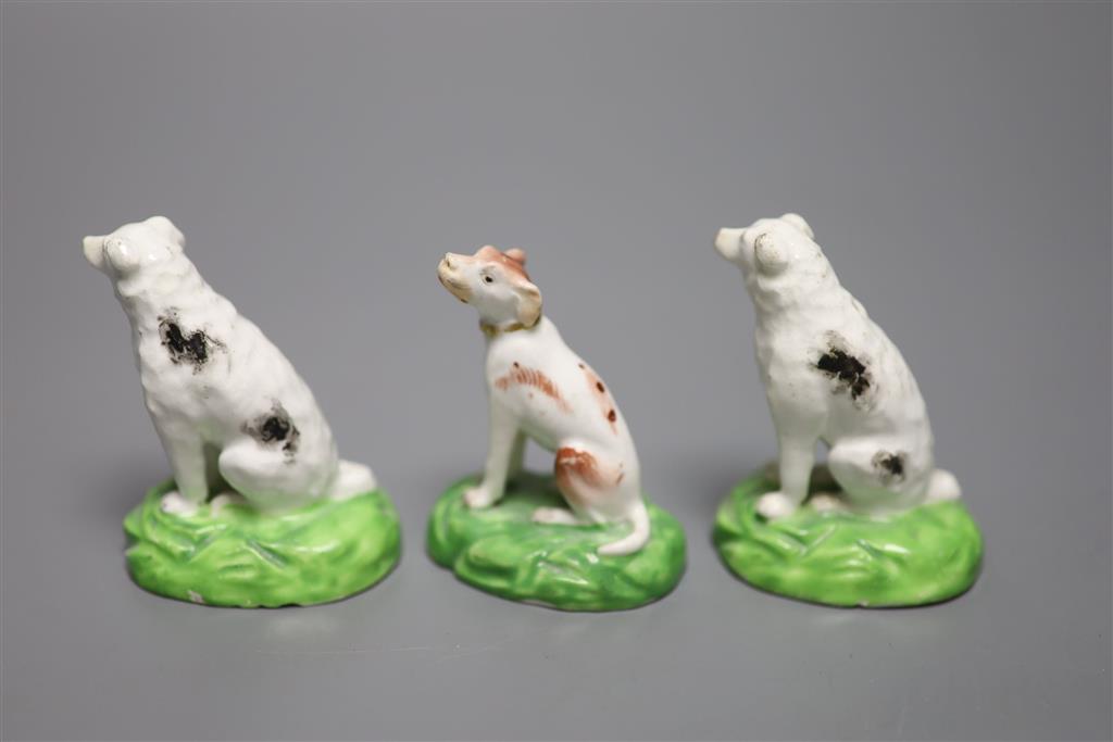 A pair of Staffordshire porcelain figures of seated dogs, height 6.5cm, and another, c.1830-50